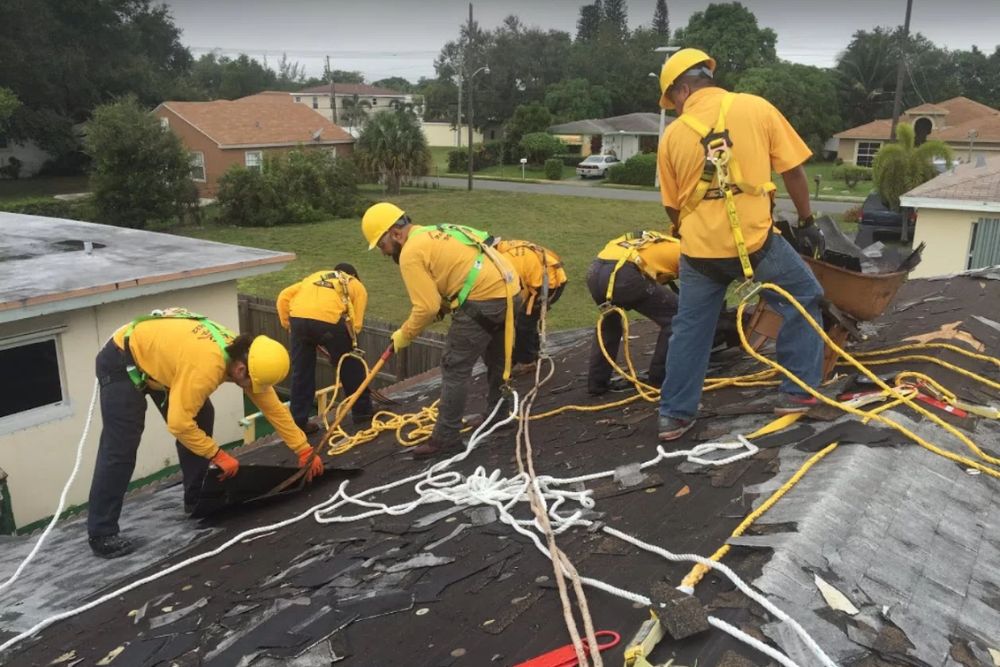 A group of workers in yellow shirts performing roof repairs, highlighting our services in Washington, DC.