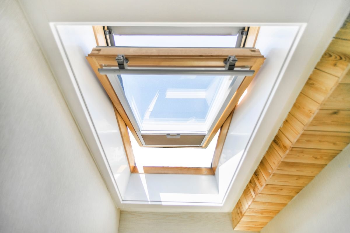 Skylight in a room with a wooden ceiling, illuminating the space with natural light.